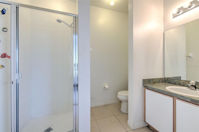 bathroom featuring vanity, toilet, tile patterned floors, and walk in shower