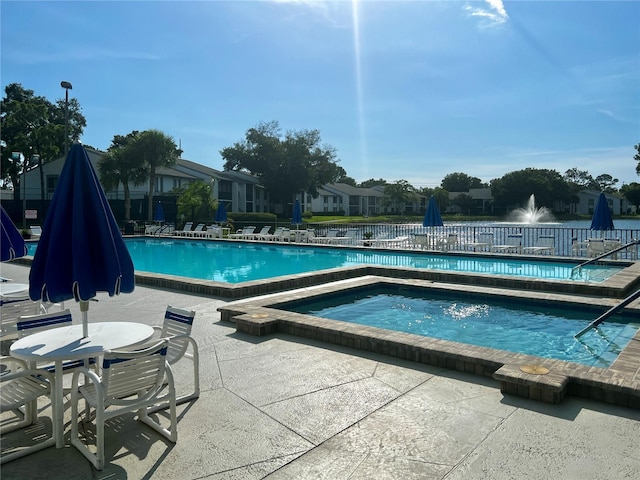 view of pool featuring a community hot tub and a patio