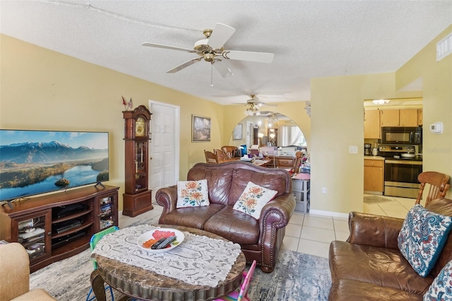 tiled living room featuring ceiling fan and a textured ceiling