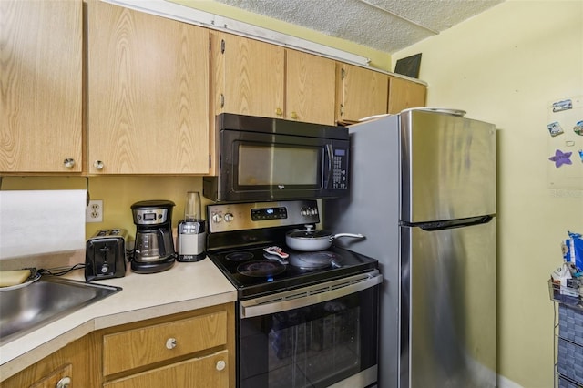 kitchen featuring a textured ceiling and stainless steel appliances