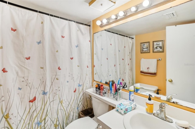 bathroom with vanity, toilet, and curtained shower