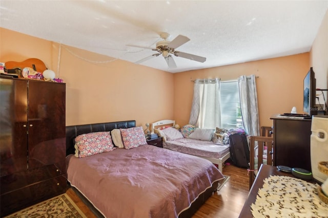 bedroom featuring ceiling fan and hardwood / wood-style flooring