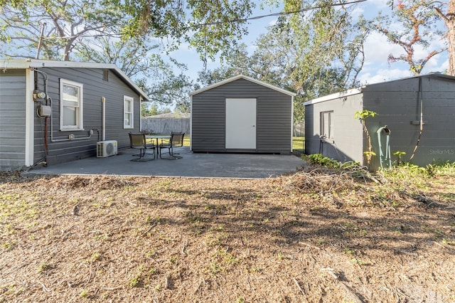 exterior space with a storage unit, a patio, and ac unit