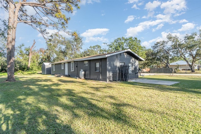 exterior space with a shed and a yard