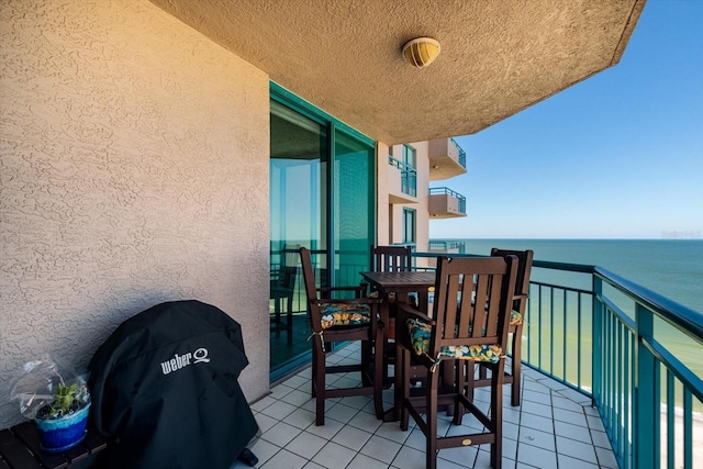 balcony featuring a water view and a grill