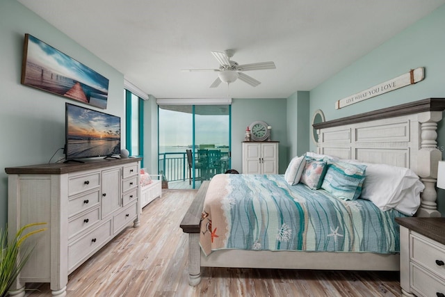 bedroom featuring light wood-type flooring, ceiling fan, access to outside, and expansive windows