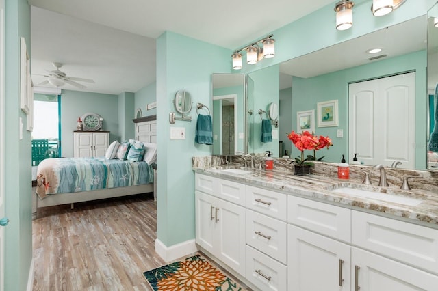 bathroom featuring ceiling fan, wood-type flooring, and vanity