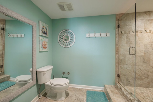 bathroom with tile patterned floors, toilet, and a shower with door