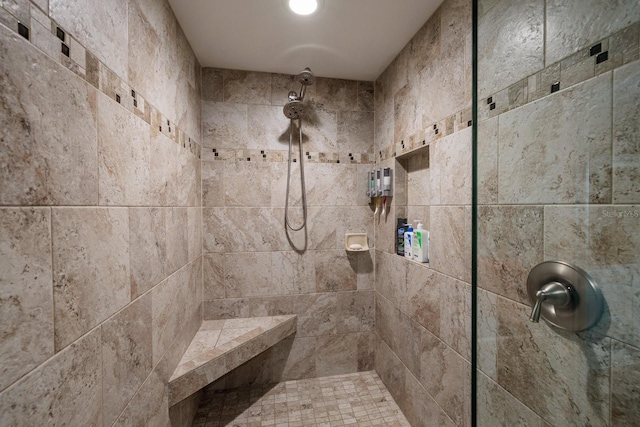 bathroom with a tile shower