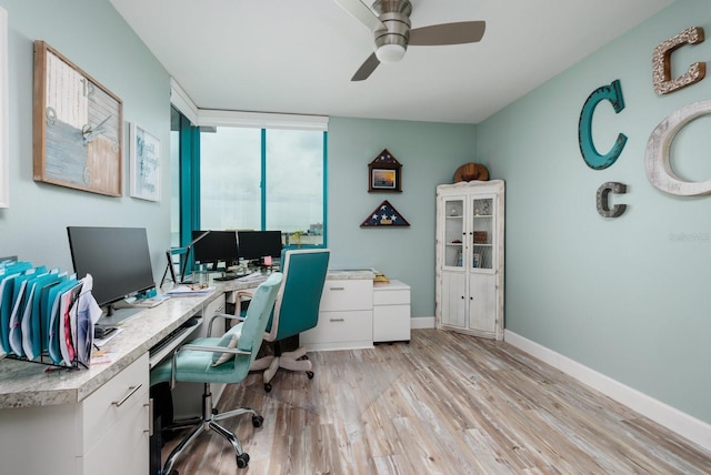 home office featuring ceiling fan and light hardwood / wood-style floors