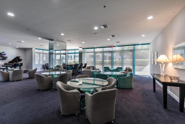 dining space with dark carpet and a healthy amount of sunlight