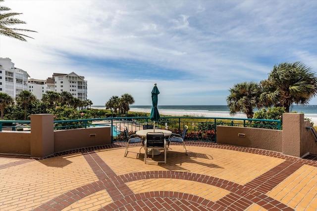 view of patio / terrace featuring a view of the beach and a water view