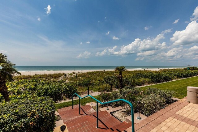 exterior space featuring a water view and a beach view