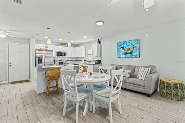 dining space with ceiling fan