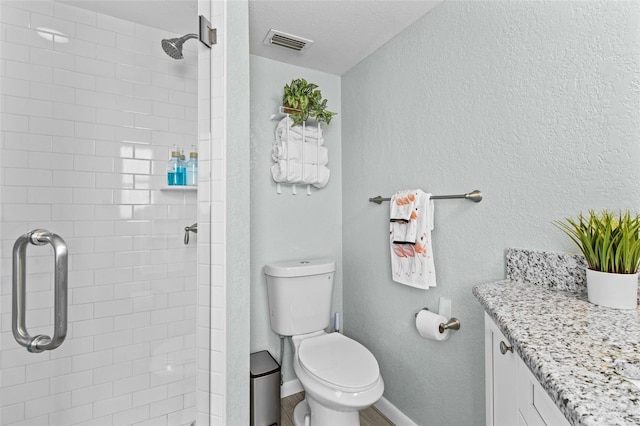 bathroom with vanity, toilet, and an enclosed shower