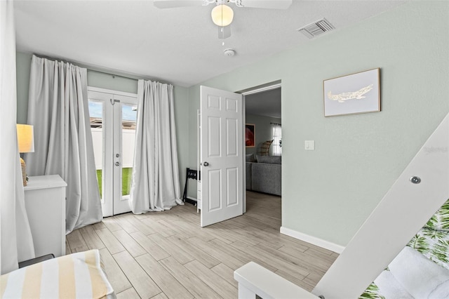 interior space featuring light hardwood / wood-style floors, ceiling fan, and french doors