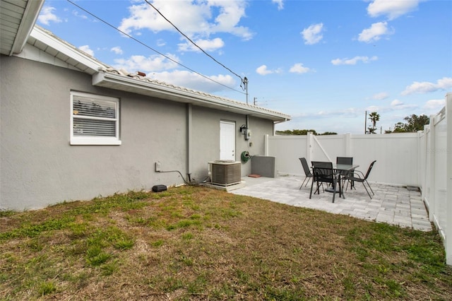 view of yard featuring central AC unit and a patio