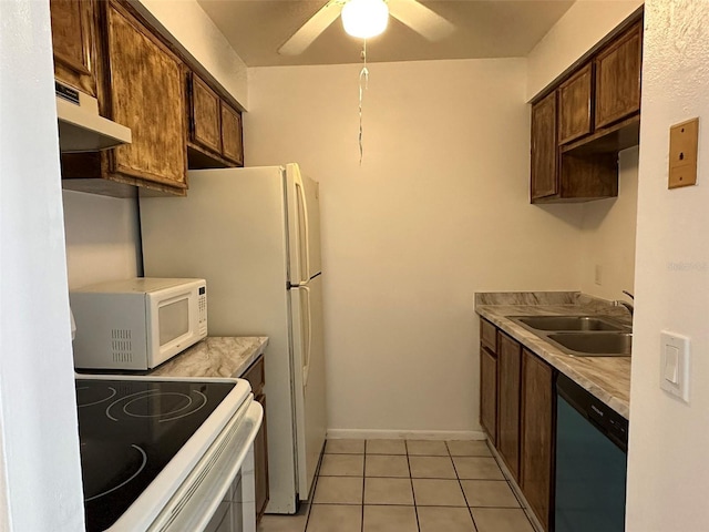 kitchen with sink, white appliances, light tile patterned floors, ceiling fan, and dark brown cabinets