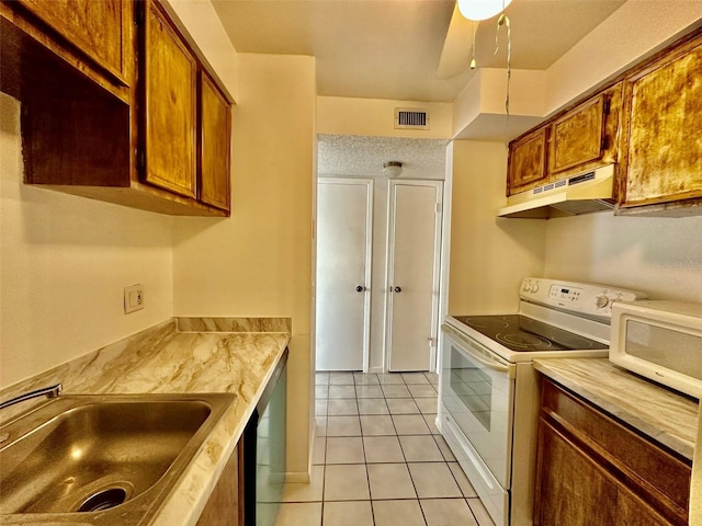 kitchen with sink, white appliances, ceiling fan, and light tile patterned flooring