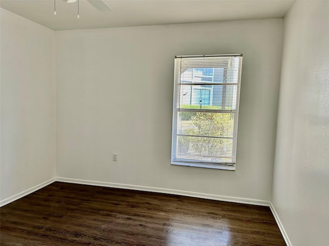 empty room with dark wood-type flooring and ceiling fan