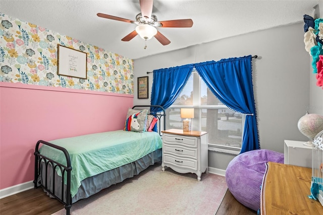 bedroom with ceiling fan and wood-type flooring