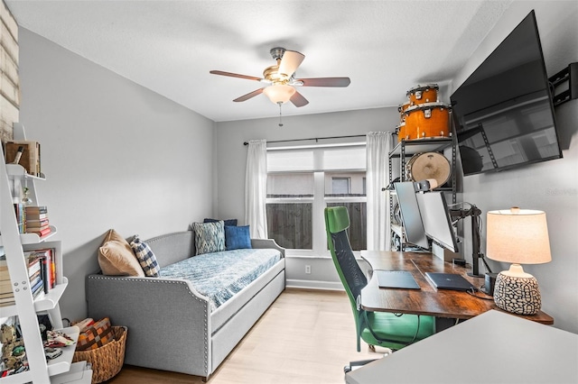 bedroom with ceiling fan and light hardwood / wood-style flooring