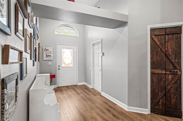 entryway with hardwood / wood-style floors