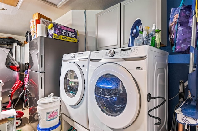 washroom with washing machine and clothes dryer