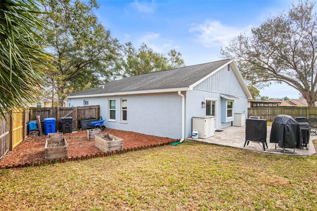 back of property featuring a yard and a patio