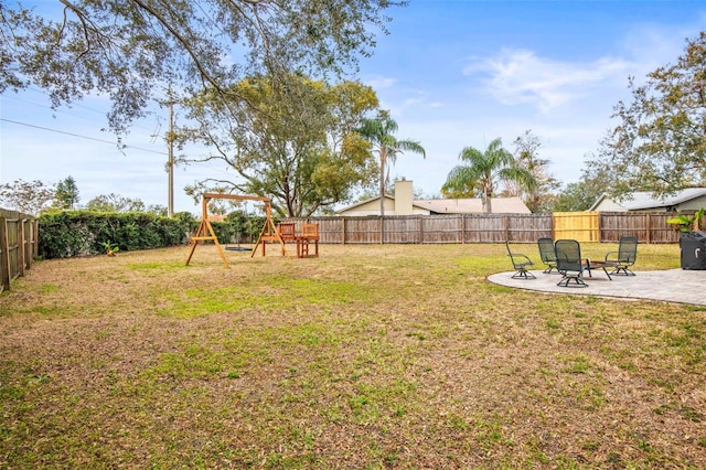 view of yard featuring a playground and a patio area