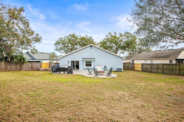 back of house with a patio area, an outdoor fire pit, a yard, and central AC