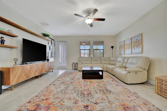 tiled living room featuring ceiling fan