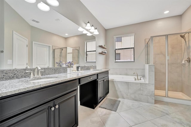 bathroom featuring separate shower and tub, vanity, and tile patterned flooring