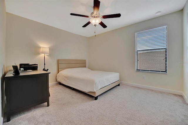 bedroom with light carpet and ceiling fan