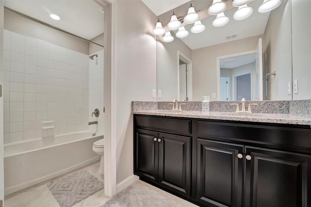 full bathroom featuring toilet, tiled shower / bath combo, and vanity