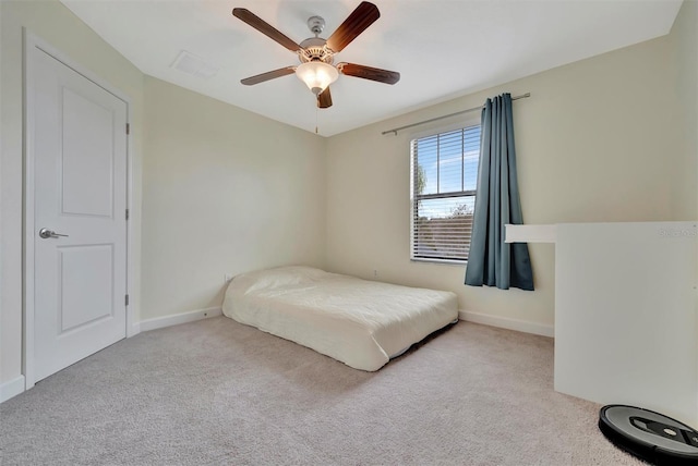 bedroom with ceiling fan and light carpet