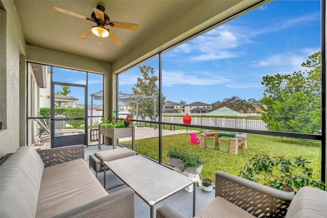 sunroom featuring ceiling fan