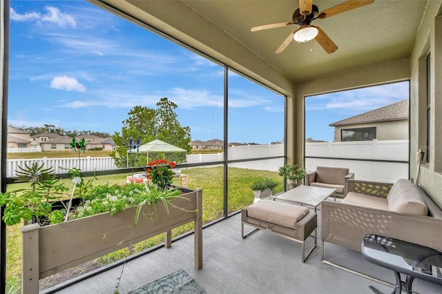 sunroom with ceiling fan and plenty of natural light