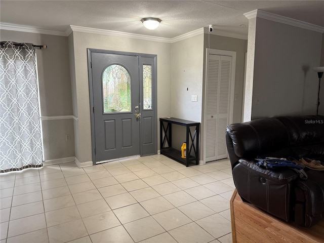 entrance foyer with crown molding, light tile patterned floors, and a textured ceiling