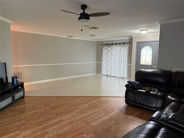 living room featuring light tile patterned floors, ceiling fan, and ornamental molding