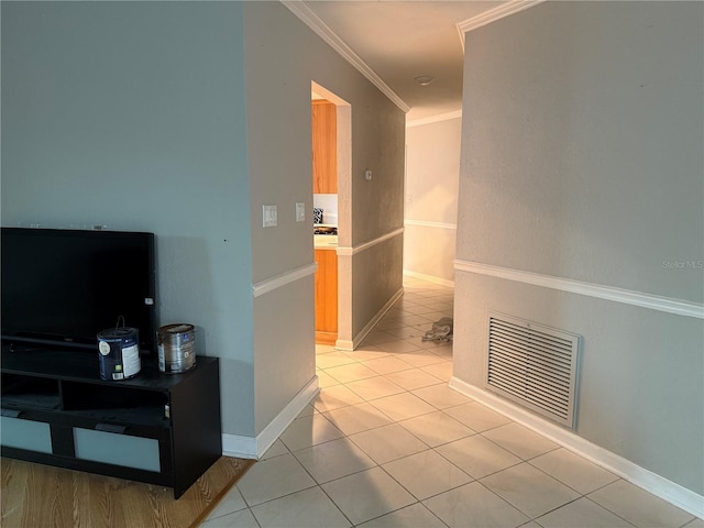 hall featuring crown molding and light tile patterned flooring