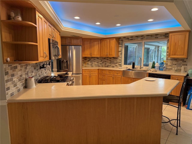 kitchen with kitchen peninsula, light tile patterned floors, a tray ceiling, and appliances with stainless steel finishes