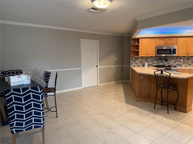 kitchen featuring kitchen peninsula, a breakfast bar area, light tile patterned floors, and stainless steel appliances