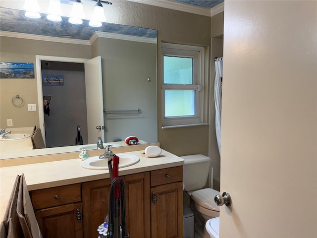 bathroom with vanity, toilet, and ornamental molding