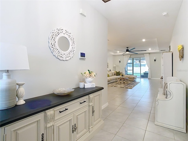 hall featuring light tile patterned floors