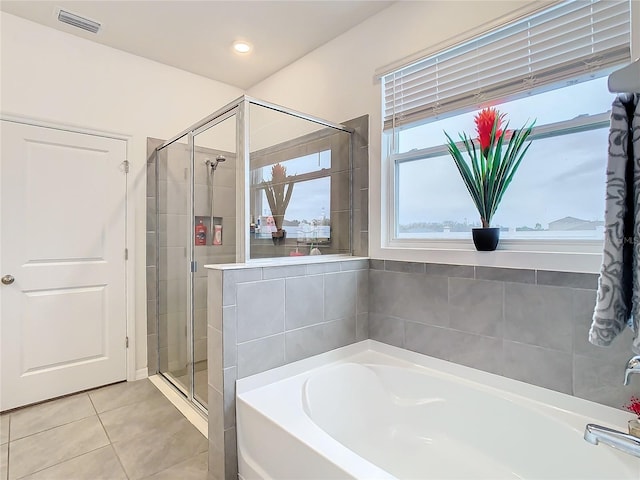 bathroom with shower with separate bathtub and tile patterned floors