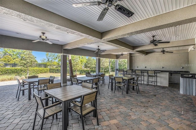 view of patio featuring exterior bar and ceiling fan