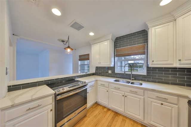 kitchen featuring sink, white cabinets, and decorative backsplash