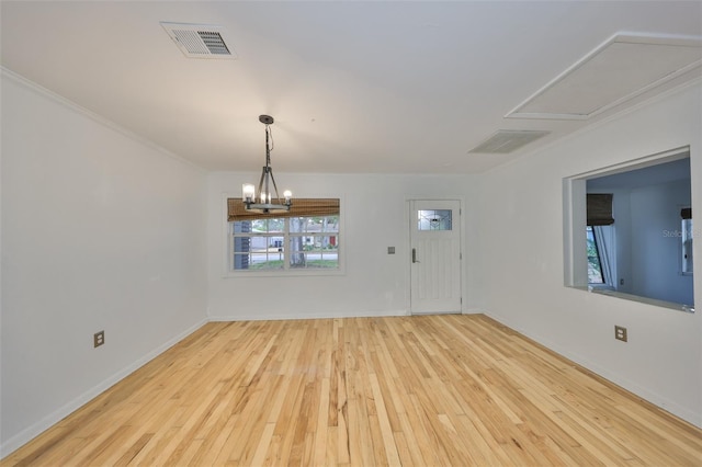 interior space with light wood-type flooring, a chandelier, and plenty of natural light