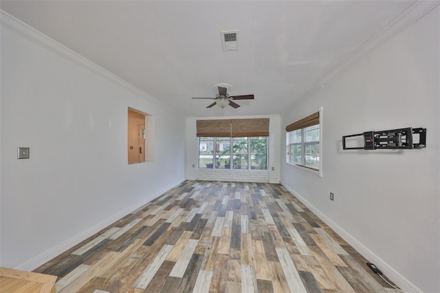 unfurnished living room featuring hardwood / wood-style flooring, ceiling fan, and crown molding